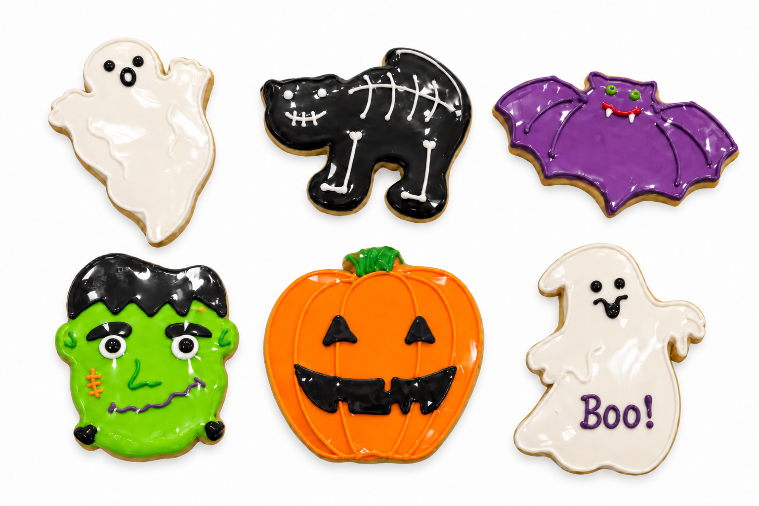 Six decorated Halloween sugar cookies: two ghosts, a skeleton cat, a bat, Frankenstein and a jack-o'-lantern