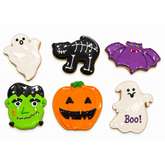Six decorated Halloween sugar cookies: two ghosts, a skeleton cat, a bat, Frankenstein and a jack-o'-lantern