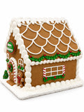 Side view of the Happy Holidays gingerbread house with a snow-capped scalloped roof and a candy-cane trimmed window