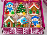 Six decorated winter cookies: two snowmen, a frosted tree and three mini gingerbread houses